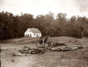 Alexander Gardner's photograph of the aftermath of Antietam. Here fallen soldiers lie strewn on the ground with a Dunker church in the background.